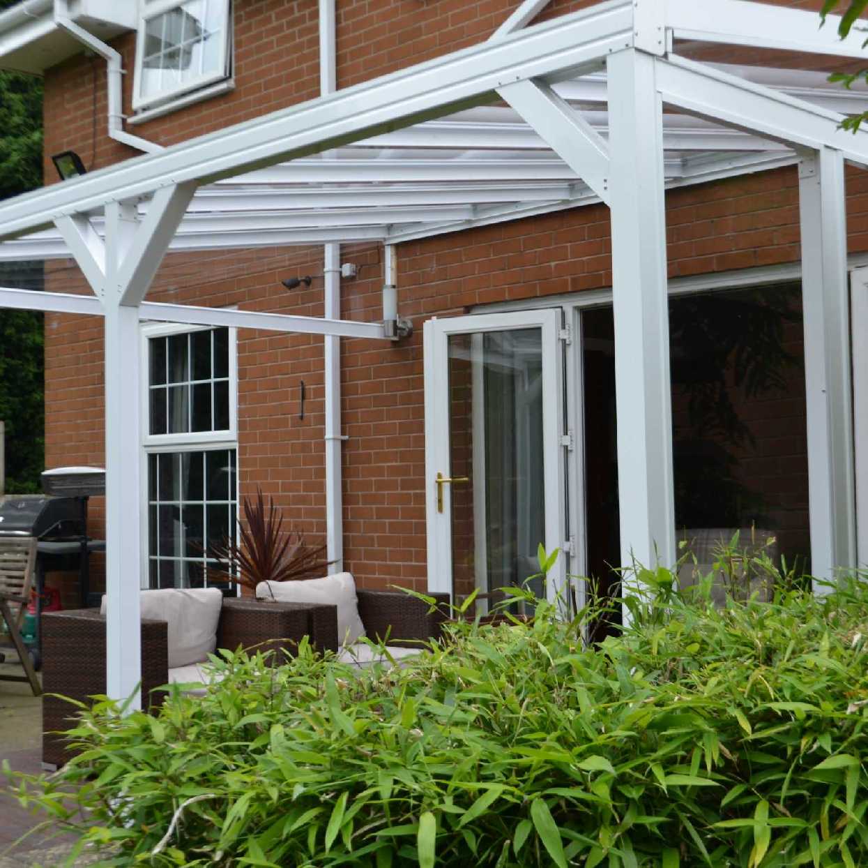 Omega Smart Lean-To Canopy, White with 6mm Glass Clear Plate Polycarbonate Glazing - 9.1m (W) x 1.5m (P), (5) Supporting Posts from Omega Build