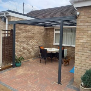 grey canopy on a brick patio with a small dog