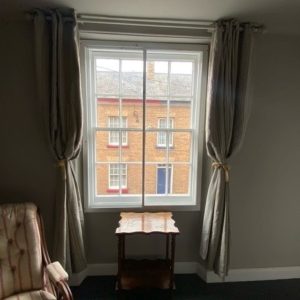 Vertical slider secondary glazing in front of a victorian sash window