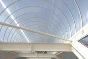 Curved polycarbonate roof on a white metal framework