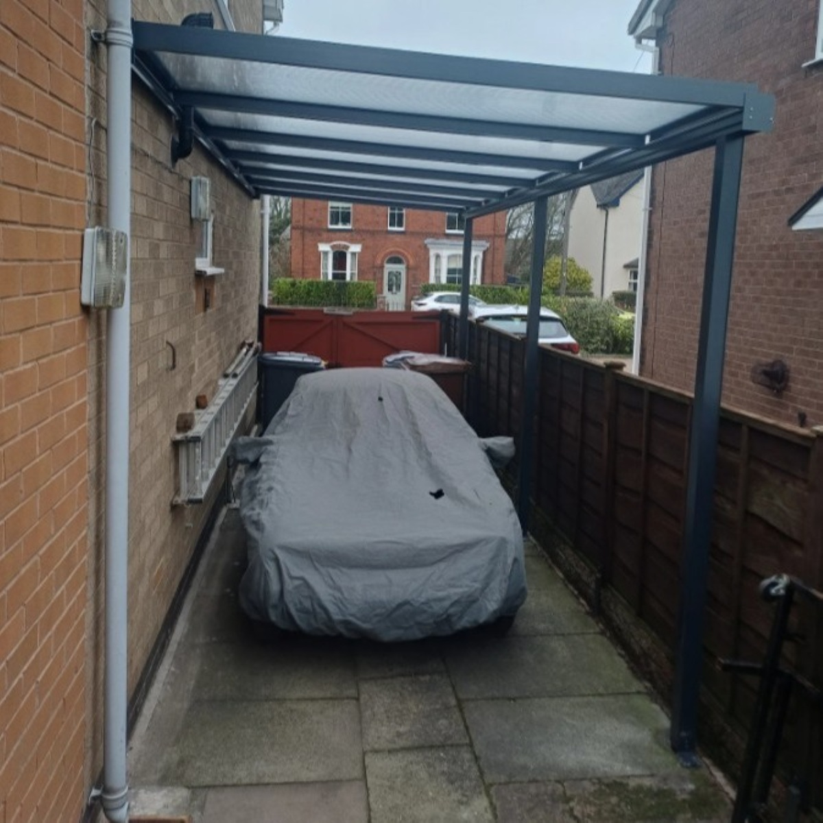 Fitting a  Smart Canopy16 Carport around down pipes